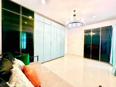Spacious bedroom with modern lighting and ample closet space