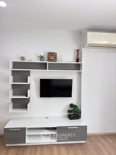 Modern living room with sleek TV unit and air conditioning, perfect for contemporary living.