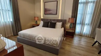 Luxurious bedroom with elegant decor and natural light, featuring a comfortable bed and stylish furnishings.