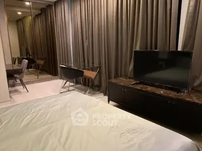 Modern bedroom with sleek furniture and large mirror closet doors, perfect for urban living.