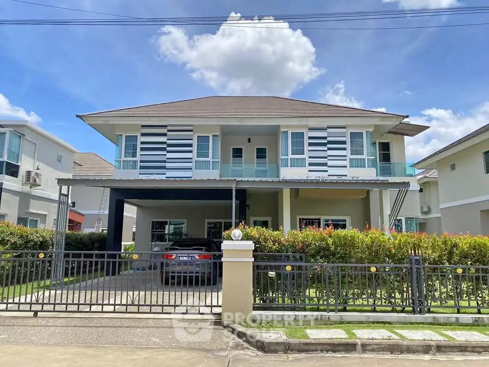 Stunning two-story modern house with spacious driveway and lush greenery.