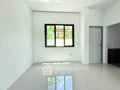 Bright and spacious empty room with large window and glossy tiled floor, perfect for customization.