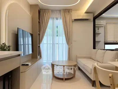 Modern living room with elegant decor, featuring a sleek TV unit, cozy sofa, and stylish coffee table.