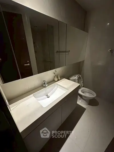 Modern bathroom with sleek fixtures and ample storage space.