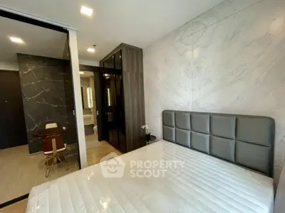 Modern bedroom with sleek design and luxurious finishes in a contemporary apartment.