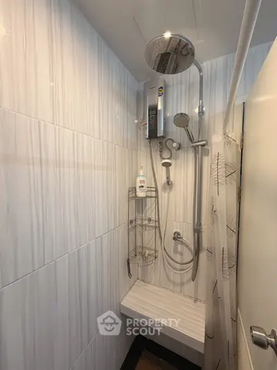 Modern bathroom with sleek shower fixtures and elegant tile design, perfect for a contemporary home.