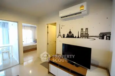 Modern living room with stylish wall art and sleek furniture in a cozy apartment setting.