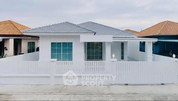 Charming single-story white house with modern design and spacious fenced yard.