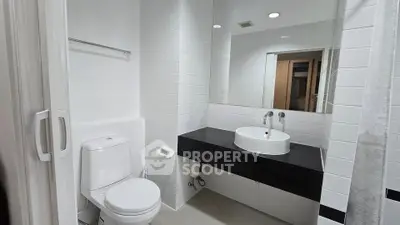 Modern bathroom with sleek white tiles and stylish fixtures