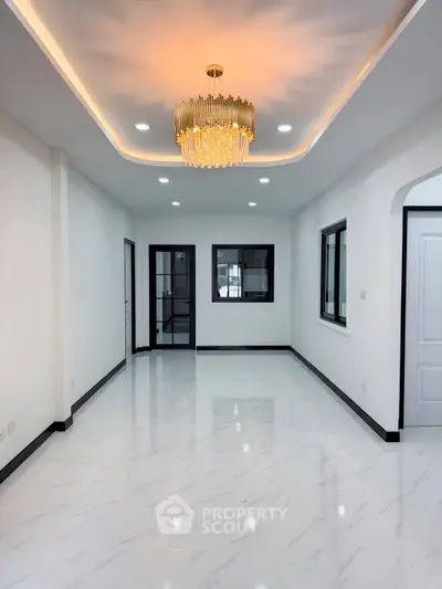 Elegant modern living room with chandelier and marble flooring