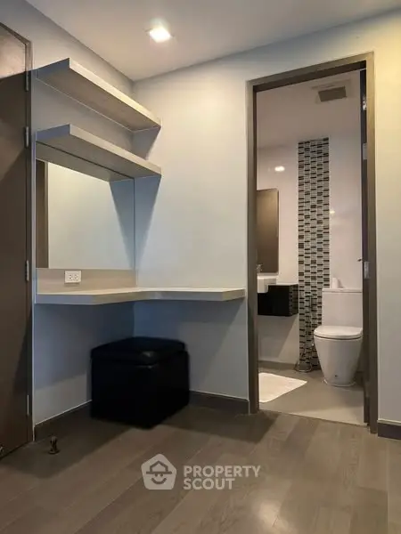 Modern bathroom with sleek design and wooden flooring