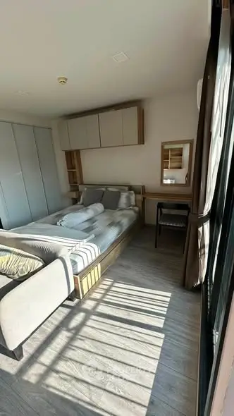 Cozy bedroom with modern furnishings and ample natural light