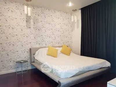 Modern bedroom with stylish brick accent wall and cozy lighting