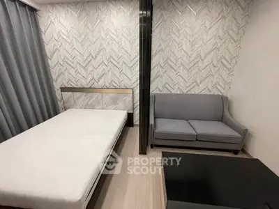 Modern bedroom with stylish decor and cozy seating area