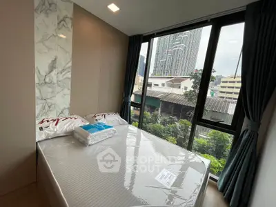 Modern bedroom with city view and large windows in urban apartment