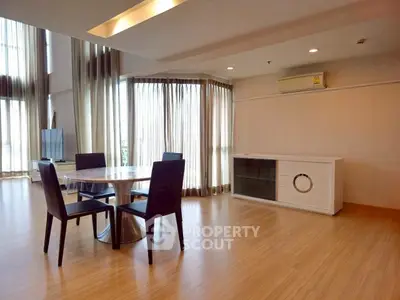 Spacious modern living room with elegant dining area and natural light