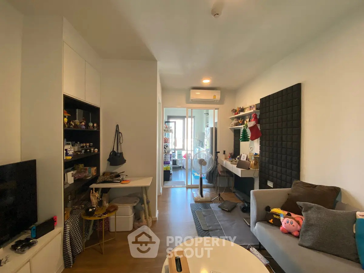 Cozy living room with modern decor and balcony access