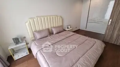 Elegant bedroom with plush bedding and modern decor in a stylish apartment.