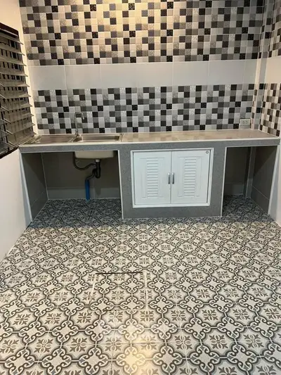 Modern kitchen with stylish patterned tiles and sleek countertops