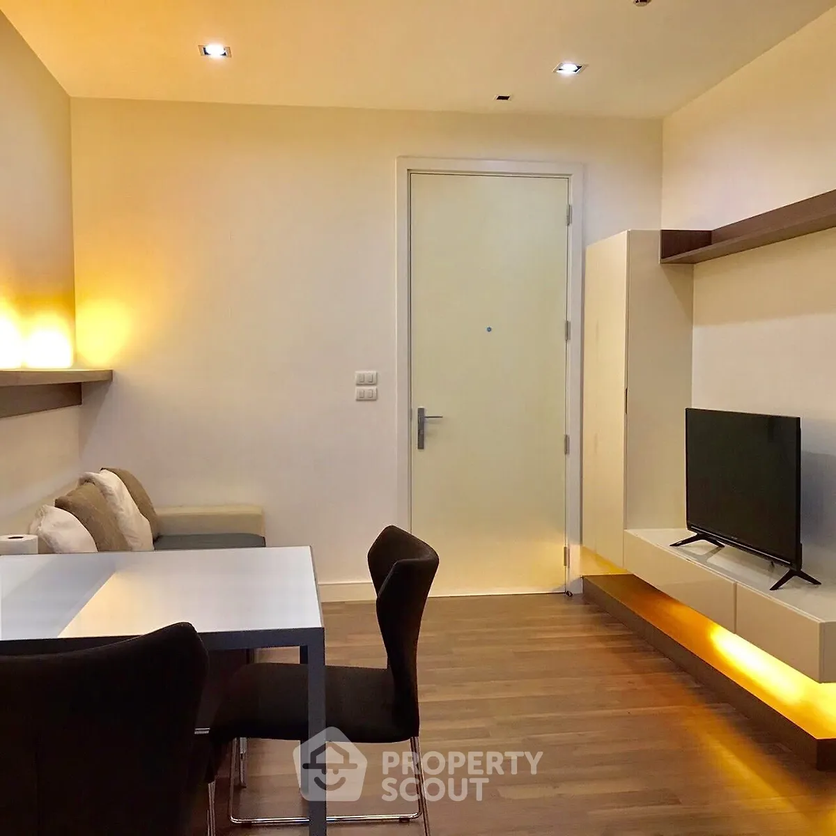 Modern living room with sleek furniture and ambient lighting, perfect for cozy relaxation.