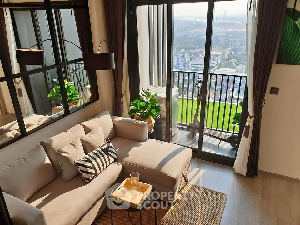 Stylish living room with balcony offering stunning city view and abundant natural light.
