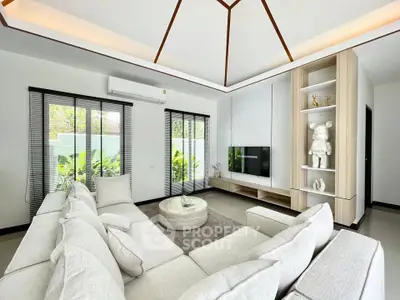 Modern living room with large white sectional sofa and stylish decor