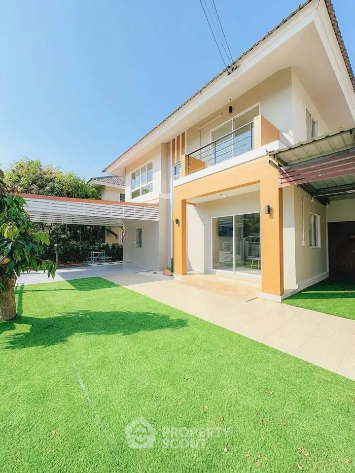 Stunning two-story house with lush green lawn and modern design, perfect for family living.