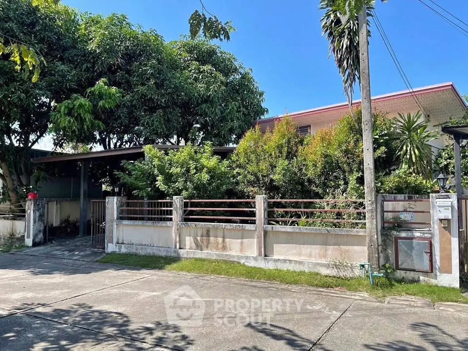 Charming suburban house with lush greenery and spacious front yard