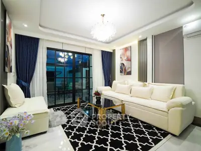 Luxurious living room with elegant decor and large windows overlooking a serene outdoor space.