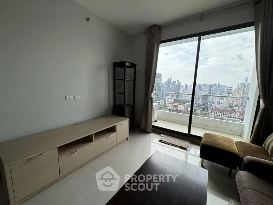 Modern living room with large window offering stunning city skyline view