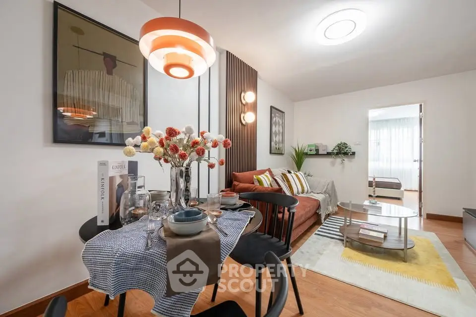 Stylish open-plan living and dining area with modern decor and cozy ambiance.