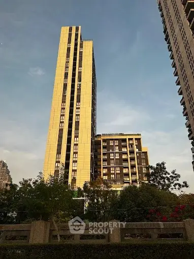 Stunning high-rise building with modern architecture and lush greenery, perfect for urban living.