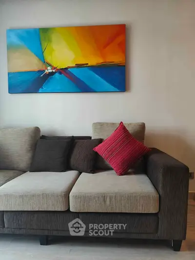 Modern living room with stylish sofa and vibrant abstract art