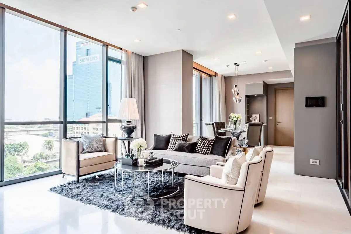 Luxurious modern living room with panoramic city views and elegant decor.