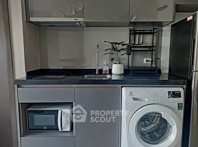 Modern compact kitchen with washing machine and microwave