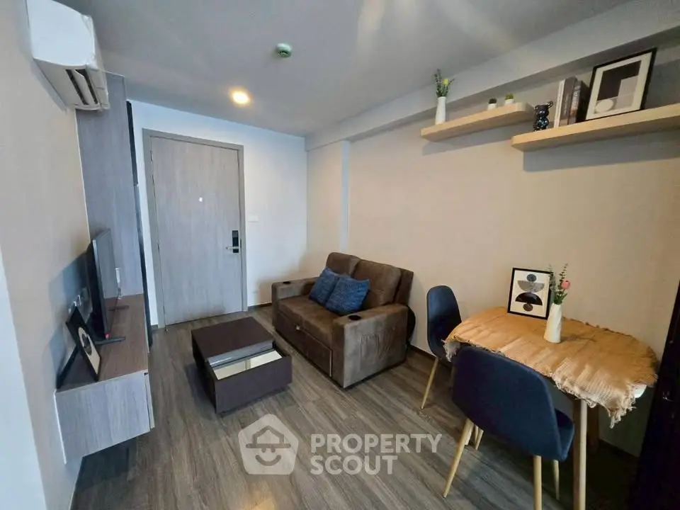 Modern living room with stylish furniture and decor, featuring a cozy sofa and dining area.