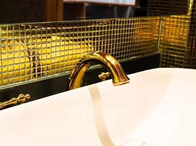 Luxurious bathroom with elegant gold faucet and stylish mosaic tiles