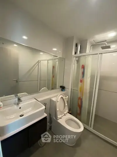 Modern bathroom with sleek fixtures and glass shower enclosure