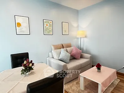 Charming living room with cozy sofa, stylish decor, and elegant dining area in modern apartment.