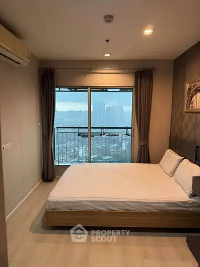Modern bedroom with city view and large window, featuring a cozy bed and elegant decor.