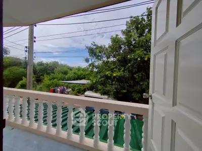 Charming balcony view with lush greenery and open sky