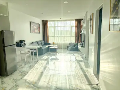 Bright and spacious living room with modern decor and large windows