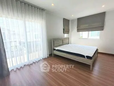 Spacious bedroom with large windows and modern decor