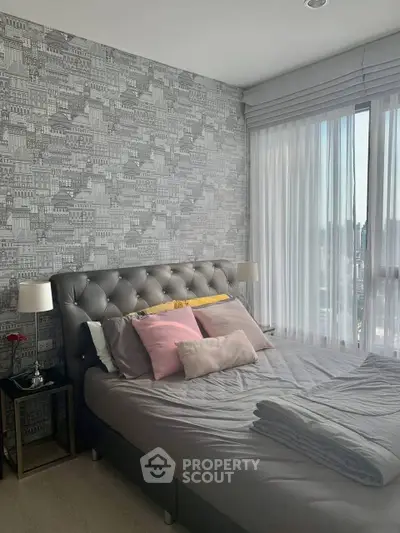 Chic bedroom with stylish wallpaper and cozy bed in modern apartment