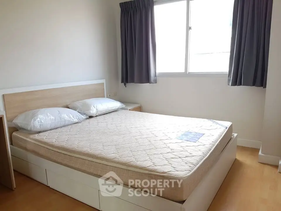 Bright and cozy bedroom with natural light and modern furnishings.