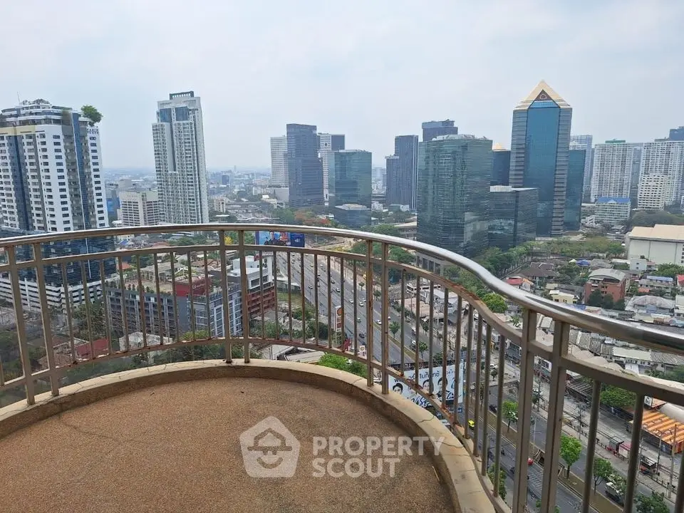 Stunning cityscape view from a high-rise balcony overlooking urban skyline.