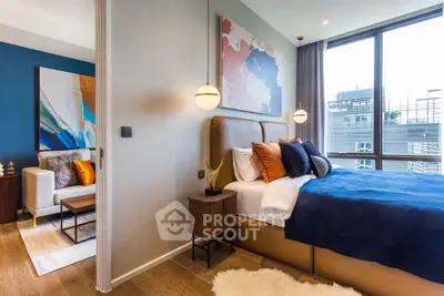 Luxurious modern bedroom with large windows and stylish decor in a high-rise apartment.