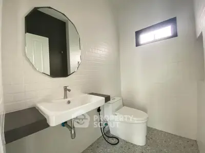 Modern minimalist bathroom with sleek fixtures and natural light