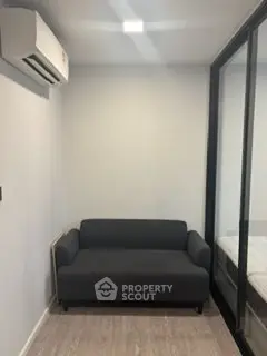 Cozy small living room with modern sofa and air conditioning