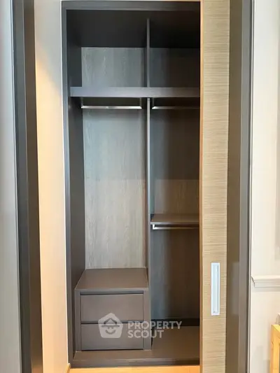 Spacious modern walk-in closet with sleek design and ample storage space.